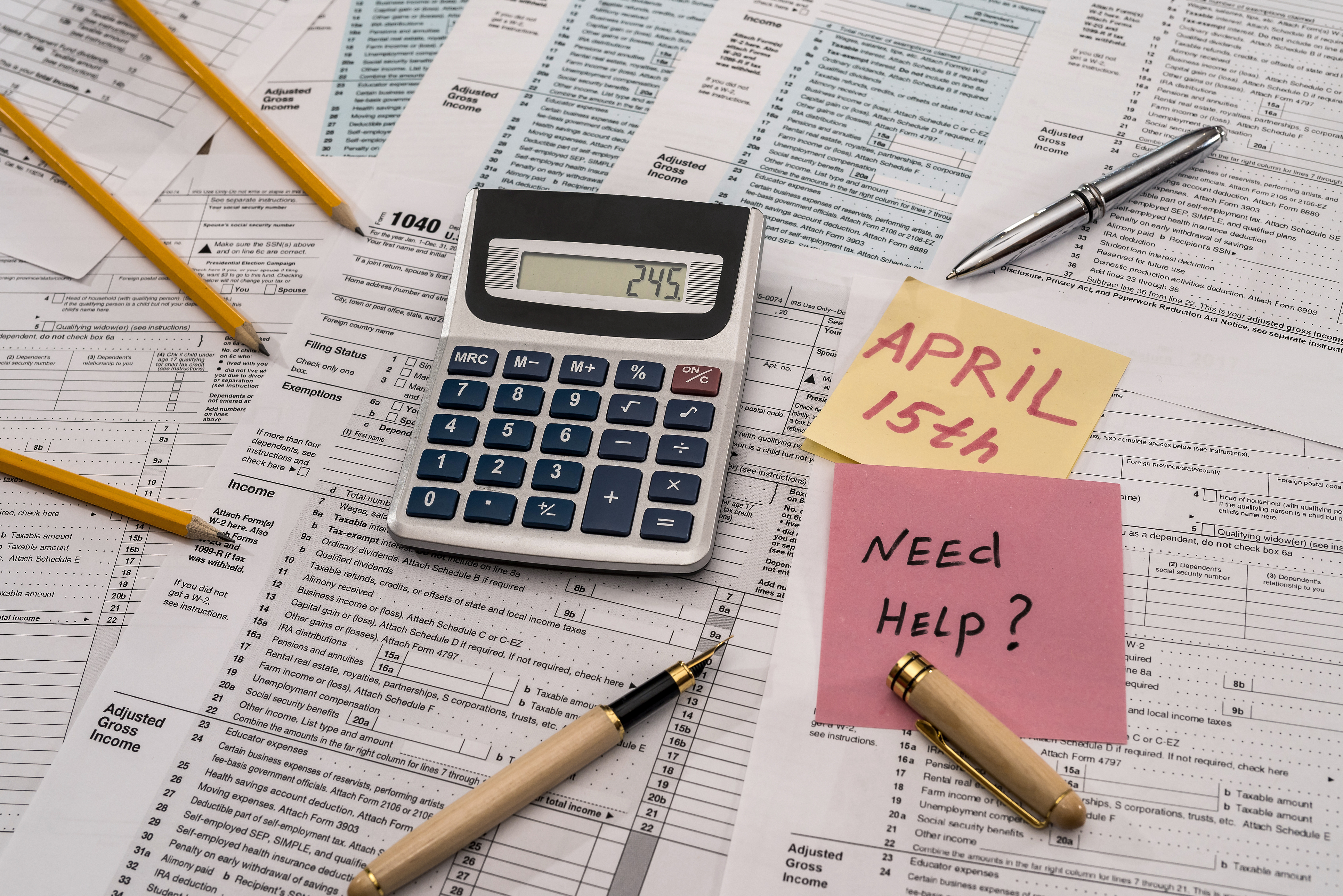 Tax forms with a "need help?" note